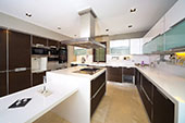 Brown kitchen with white benchtops